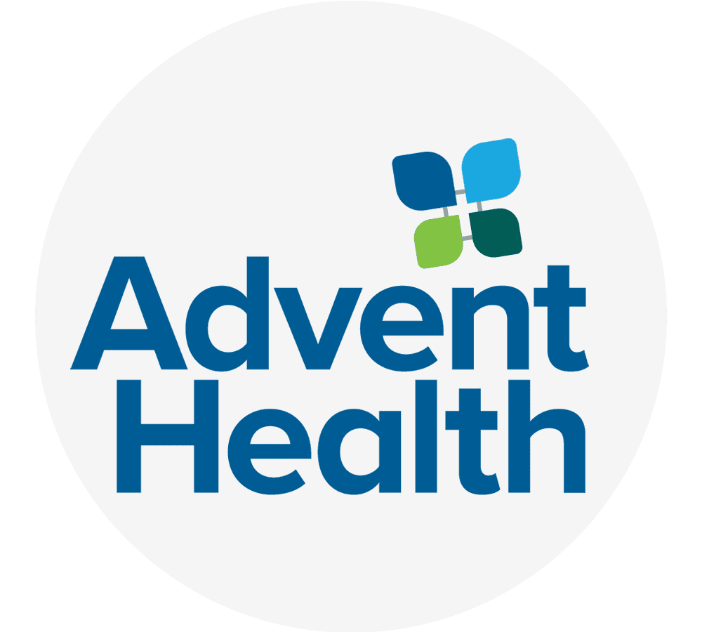 adventhealth-logo-circle-sita. AdventHealth logo featuring bold blue wordmark and a four-petal icon in blue, teal, and green on a light gray circular background