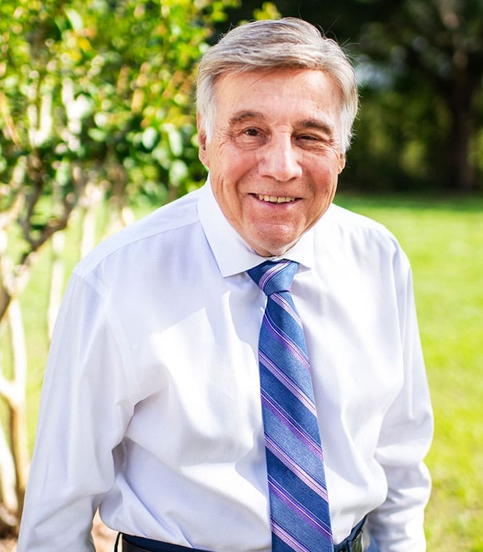 charles-w-kaupp-in-dress-shirt-and-tie-outdoors-sita. Charles W. Kaupp, The Sr. Vice President of SITA, posing and smiling for the picture