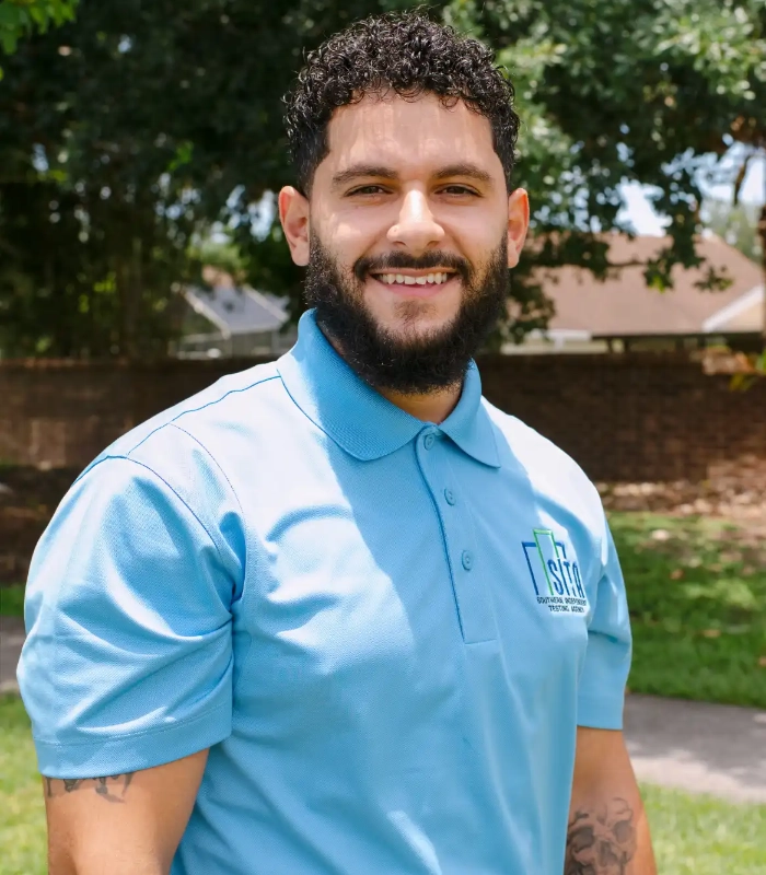 SITA field technician in a light blue branded polo smiling outdoors
