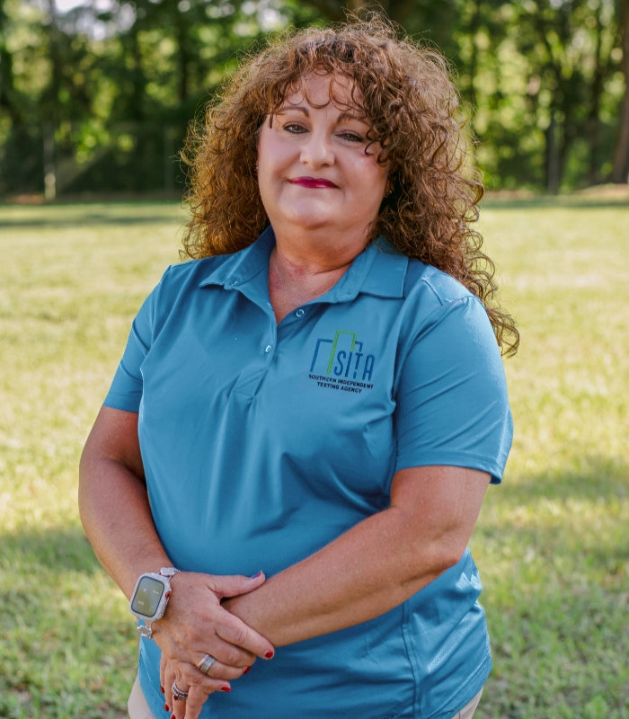 Southern Independent Testing Agency team member in a teal SITA polo smiling outdoors