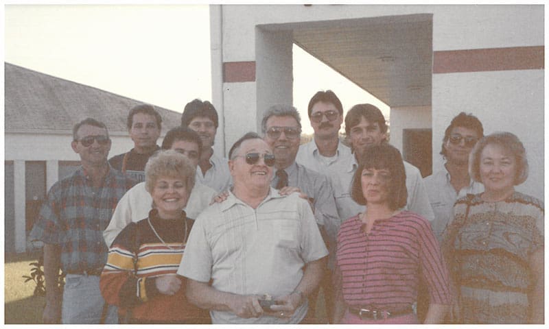 vintage-company-team-group-photo-outdoor-sita. Vintage group photo of SITA company team members outdoors